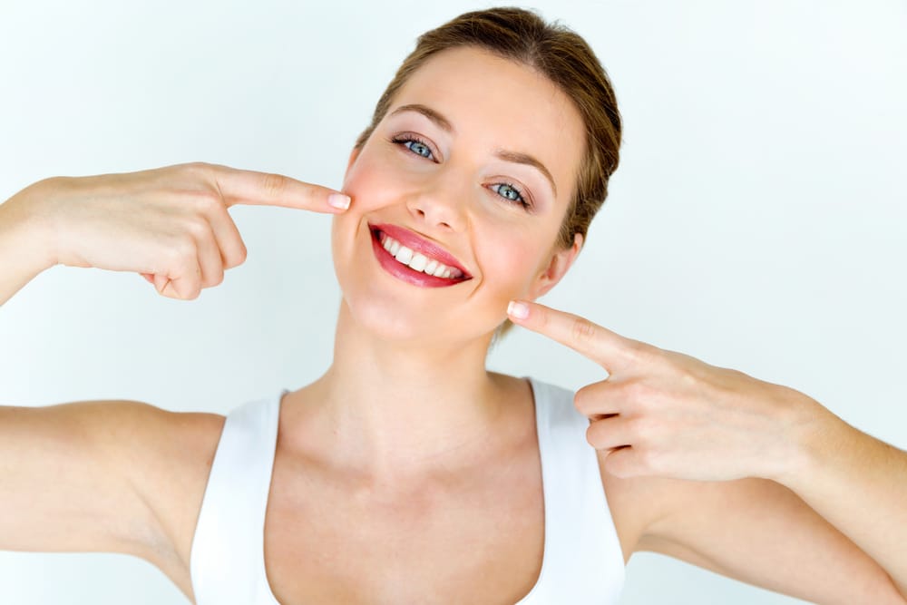 woman showing off bright, white smile after professional teeth whitening in Ocala, FL