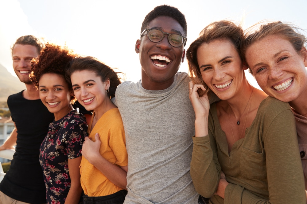 group of friends smiling after getting root canal treatments at Ocala dentist