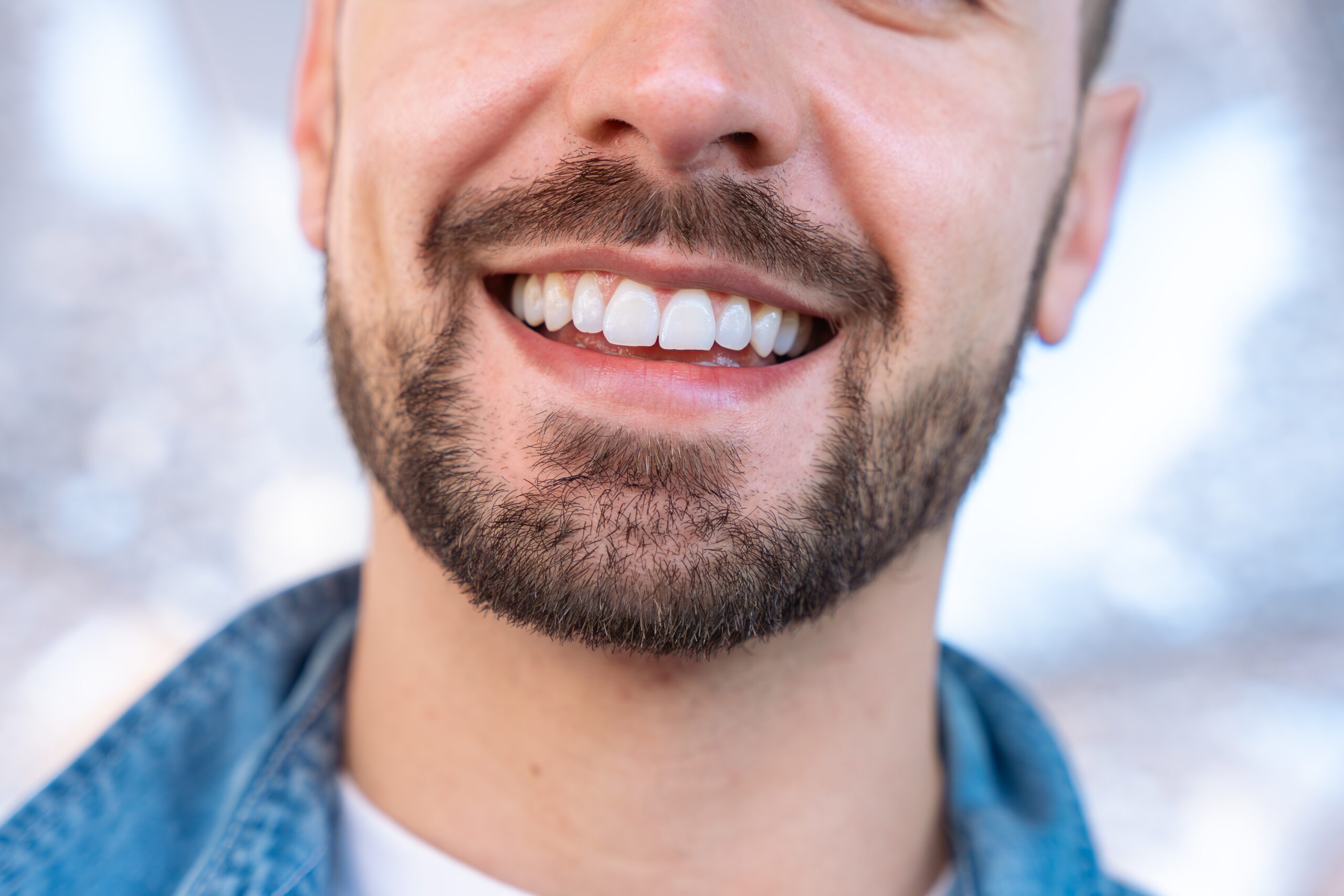 closeup of a man with a beard smiling, perfect white teeth
