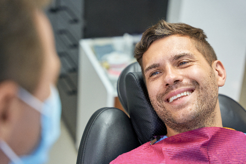 closeup of a male patient smiling, newly bonded teeth